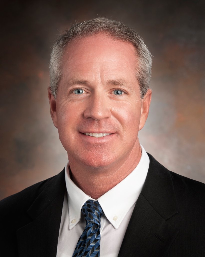 Portrait of Wendell Edwards smiling and wearing a business suit.