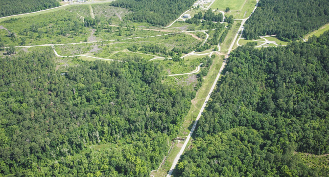 Aerial view of fields, trees, and dirt roads