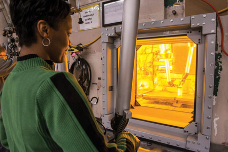Woman looking into a glowing yellow window