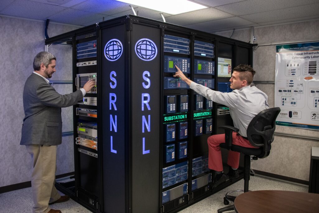 Two employees checking working and checking on a server