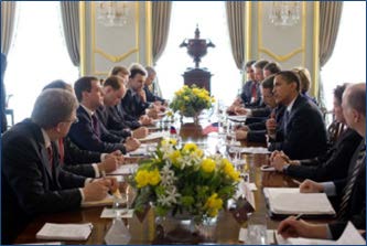 a group of people sitting at a long table