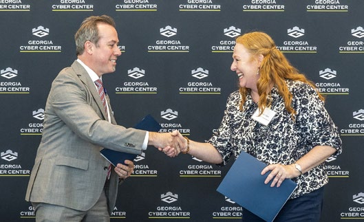 a man and woman smiling and shaking hands